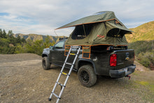 Load image into Gallery viewer, Vagabond Lite Rooftop Tent in Forest Green Hyper Orange with telescopic ladder shown on a truck
